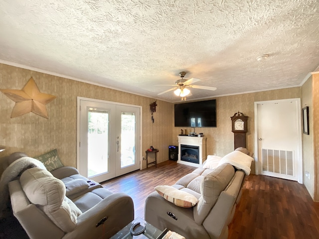 living room featuring a textured ceiling, ceiling fan, and dark wood-type flooring