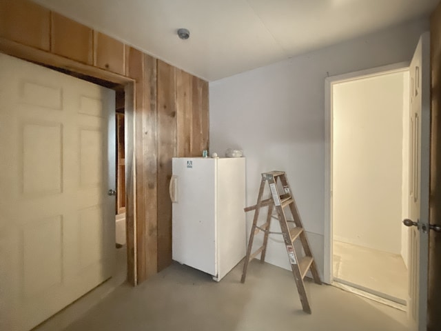 clothes washing area with wood walls