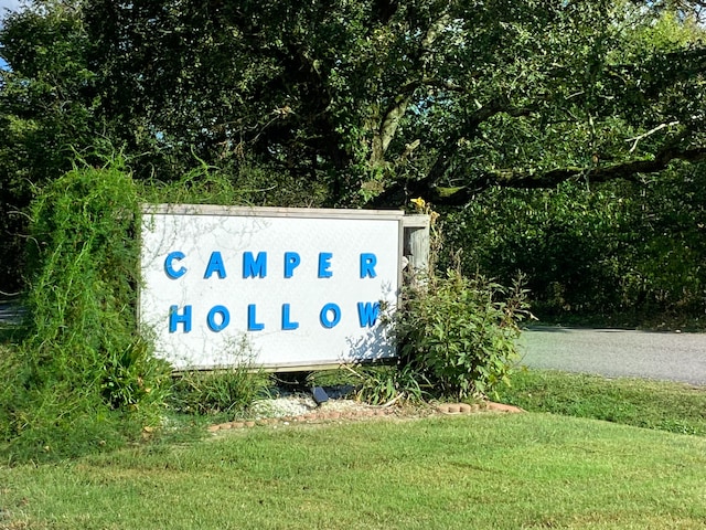 community / neighborhood sign with a yard