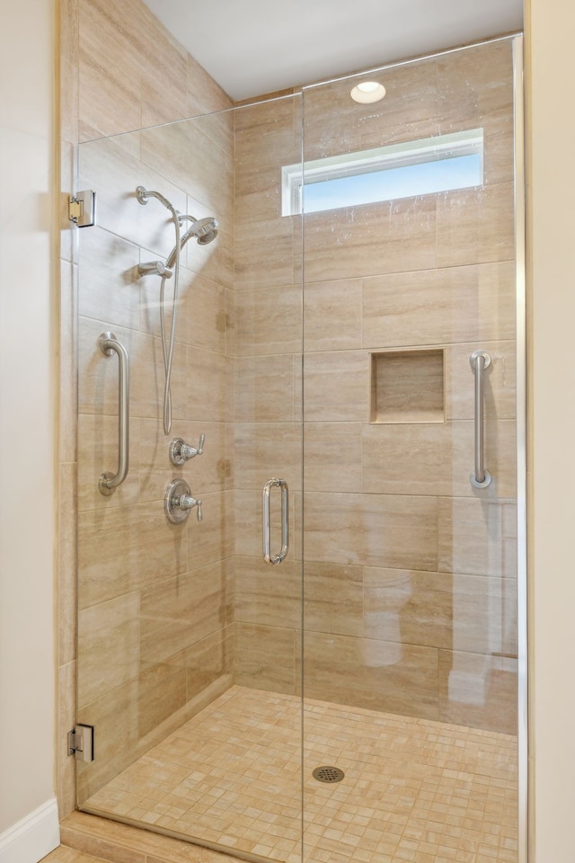 bathroom with a shower with shower door