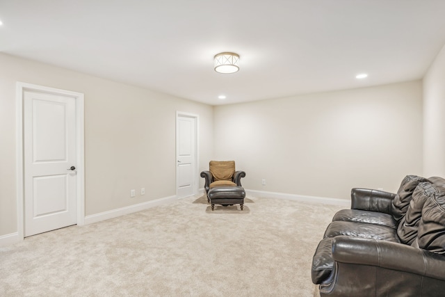 sitting room featuring light colored carpet