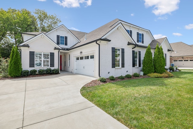 view of front of property featuring a garage and a front lawn