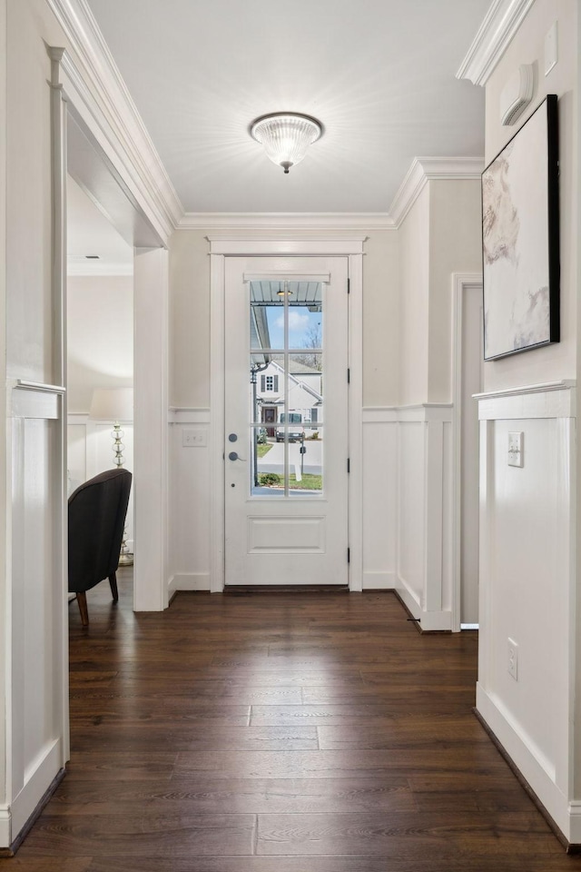 foyer entrance with crown molding and dark hardwood / wood-style floors