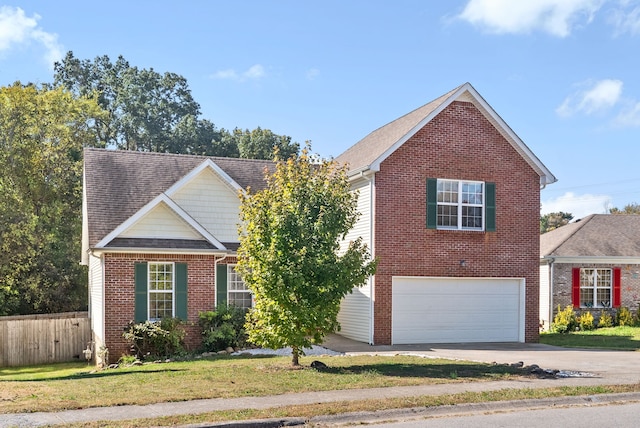 front of property featuring a front yard and a garage