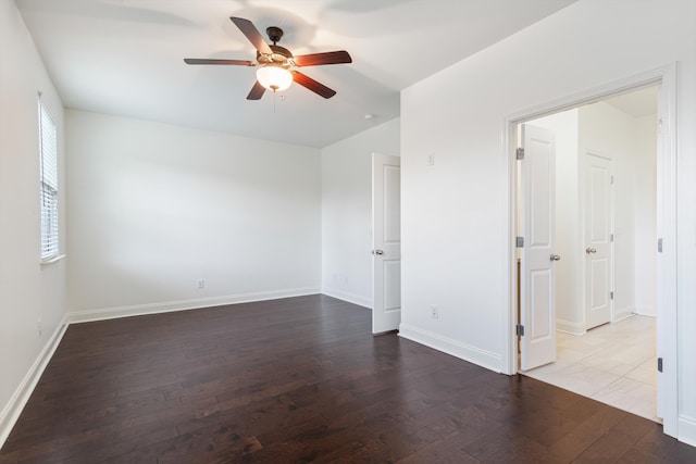 empty room featuring ceiling fan and dark hardwood / wood-style floors