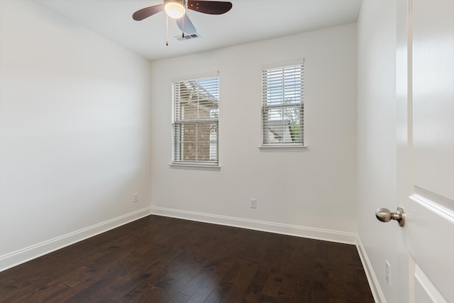 spare room with dark wood-type flooring and ceiling fan