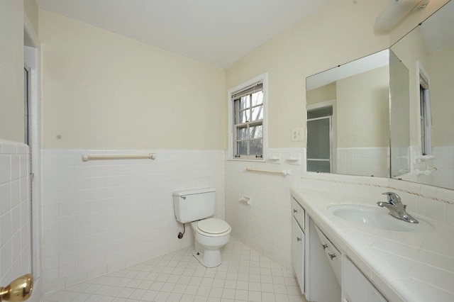 bathroom with tile walls, tile patterned floors, vanity, and toilet