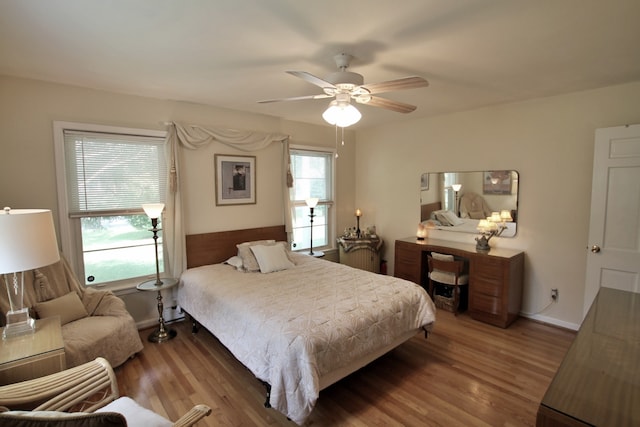 bedroom with ceiling fan and hardwood / wood-style floors