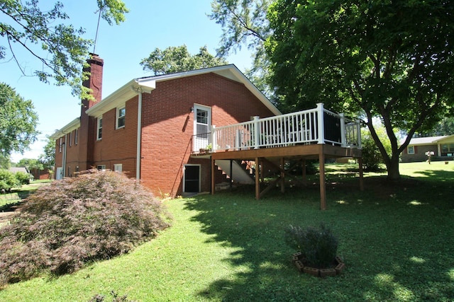 back of house featuring a yard and a wooden deck