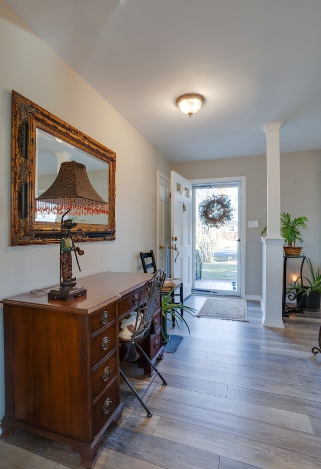 interior space featuring light hardwood / wood-style flooring and ornate columns