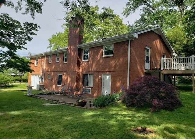 rear view of house featuring a lawn, a wooden deck, and central AC unit