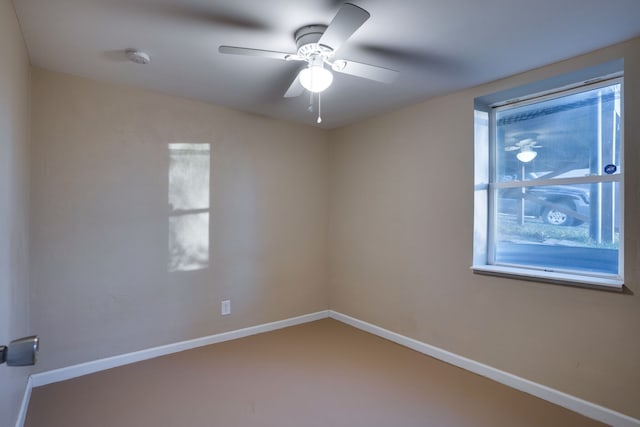 carpeted spare room with ceiling fan