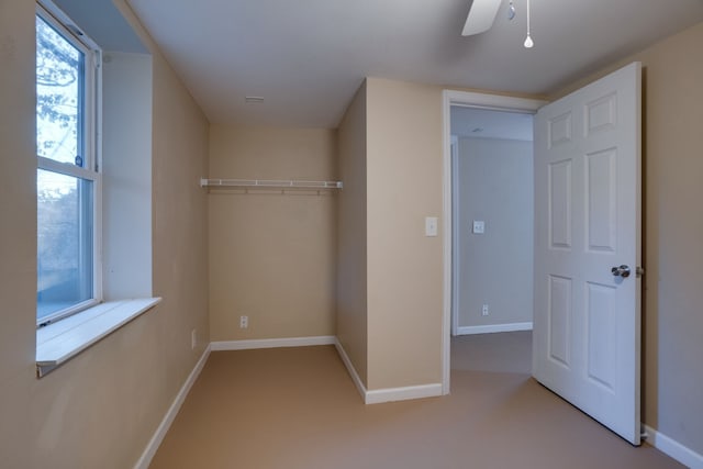 interior space featuring ceiling fan and a closet