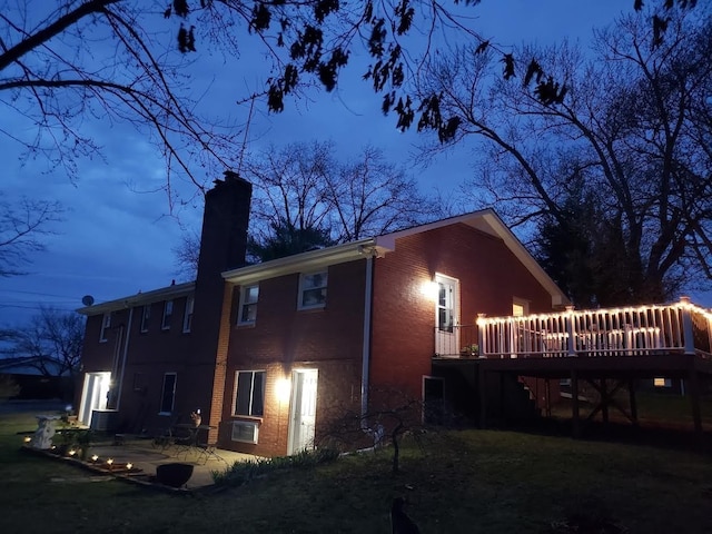 back of property featuring a patio and a deck