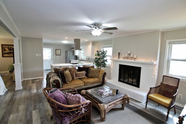 living room featuring ceiling fan, plenty of natural light, and wood-type flooring