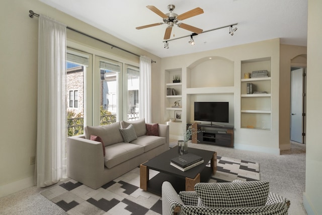 living room featuring light carpet, built in features, and ceiling fan