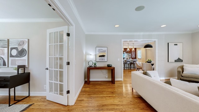 living room with crown molding and light hardwood / wood-style floors