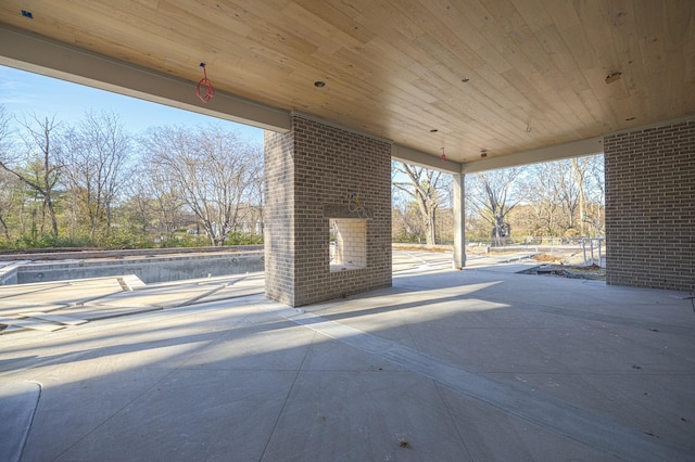 view of patio / terrace featuring an outdoor brick fireplace