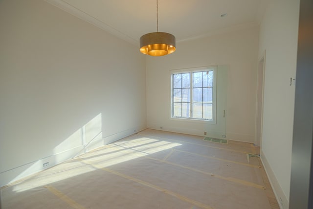 spare room with crown molding