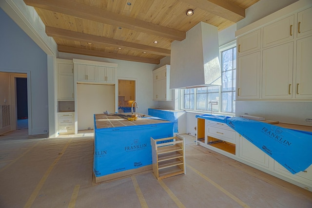 kitchen with wood ceiling, premium range hood, a center island, tile countertops, and beamed ceiling