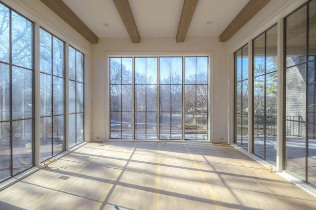 unfurnished sunroom with beam ceiling