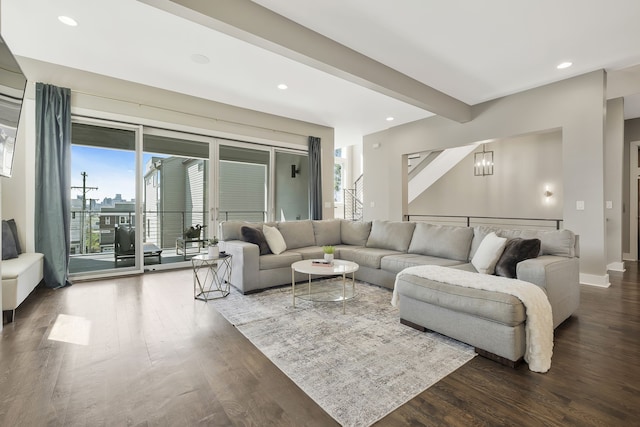 living room with a chandelier and dark hardwood / wood-style flooring