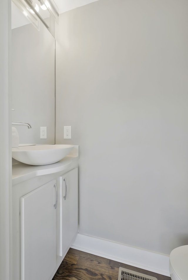 bathroom featuring hardwood / wood-style floors, vanity, and toilet