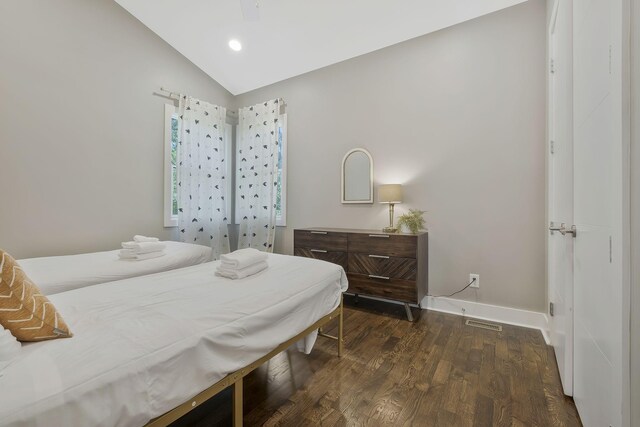 bedroom featuring lofted ceiling, ceiling fan, and dark hardwood / wood-style floors