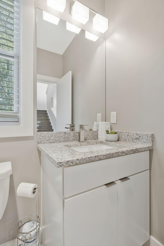 bathroom featuring hardwood / wood-style floors, vanity, and toilet