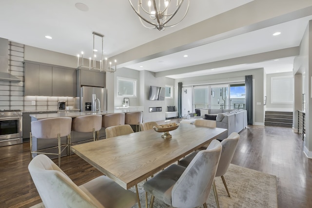 dining space featuring dark hardwood / wood-style floors and a chandelier