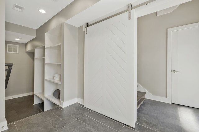 walk in closet featuring a barn door