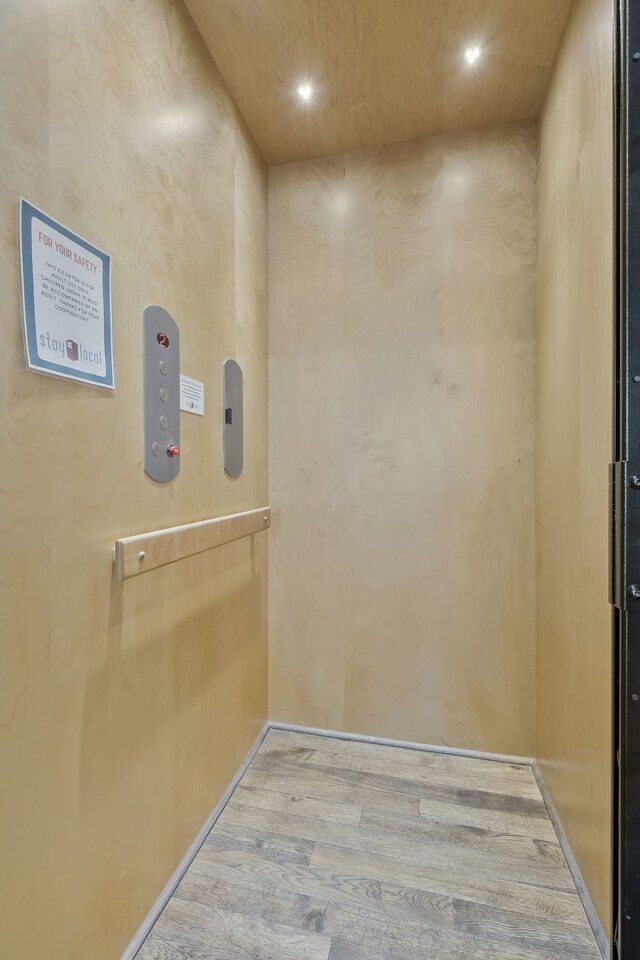 room details with wood-type flooring and elevator