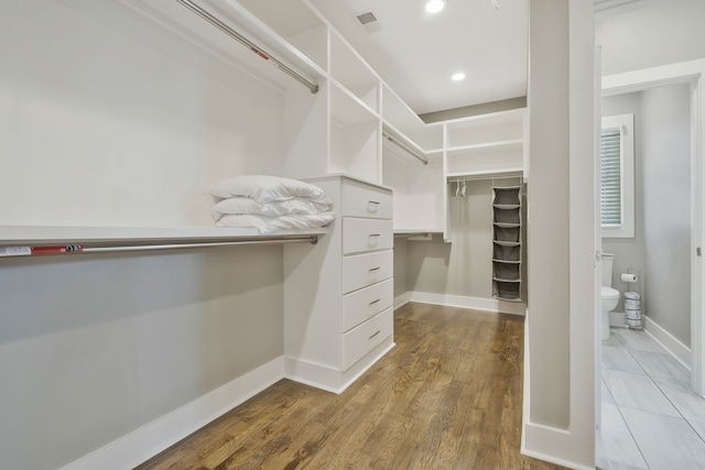 spacious closet with hardwood / wood-style floors