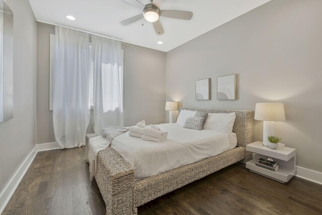 bedroom with ceiling fan and dark hardwood / wood-style floors