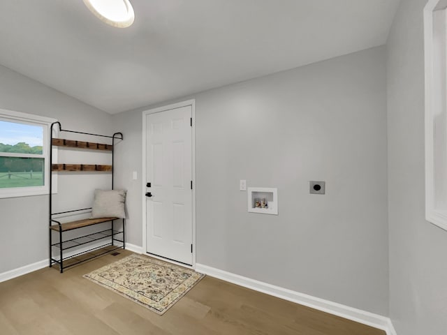 clothes washing area with light wood-type flooring, hookup for a washing machine, and electric dryer hookup