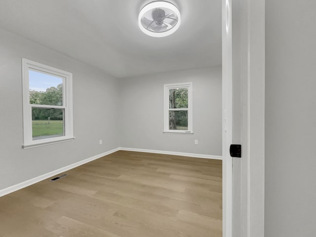 empty room featuring ceiling fan and light hardwood / wood-style flooring