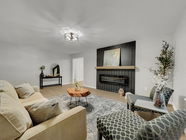 living room featuring light hardwood / wood-style flooring and a fireplace