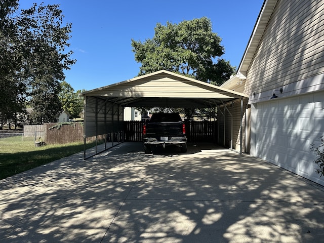 view of parking / parking lot featuring a carport and a garage