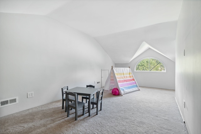 recreation room with light carpet and vaulted ceiling