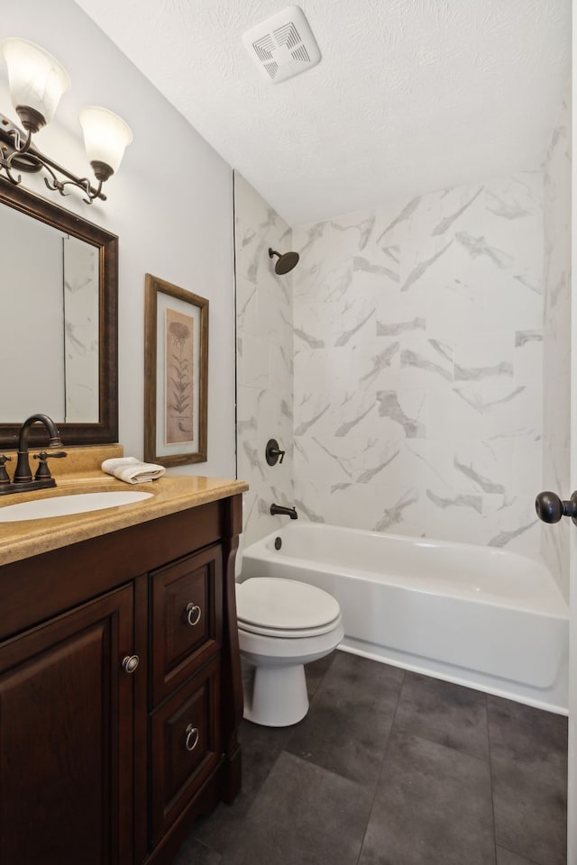 full bathroom with a textured ceiling, vanity, toilet, and tiled shower / bath