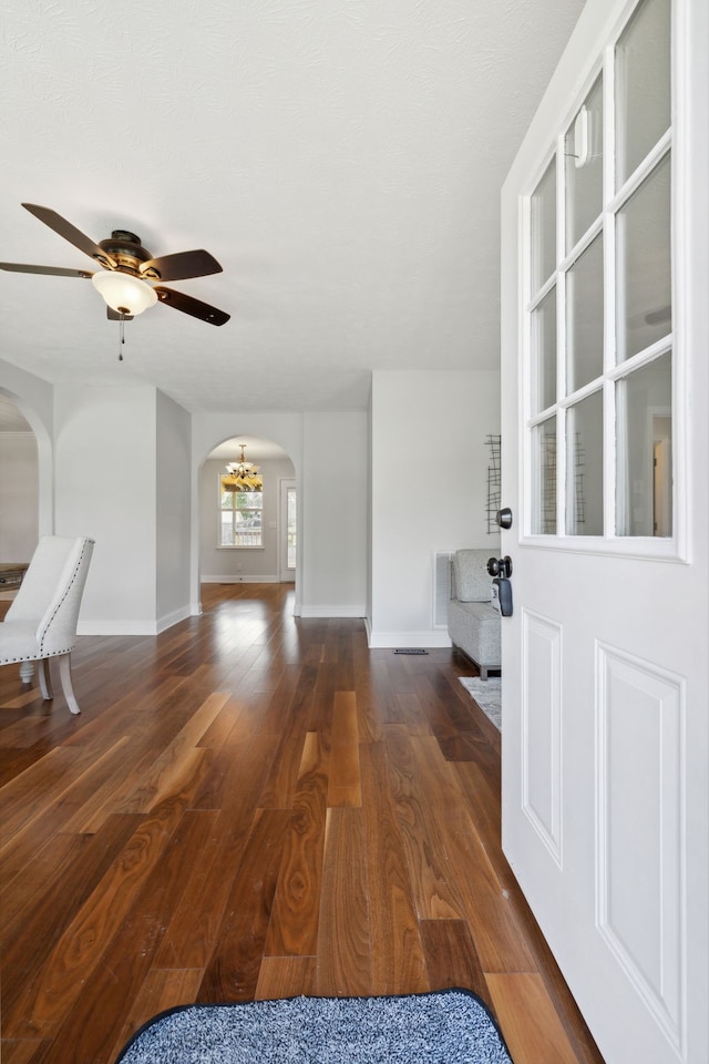 interior space with ceiling fan and dark wood-type flooring