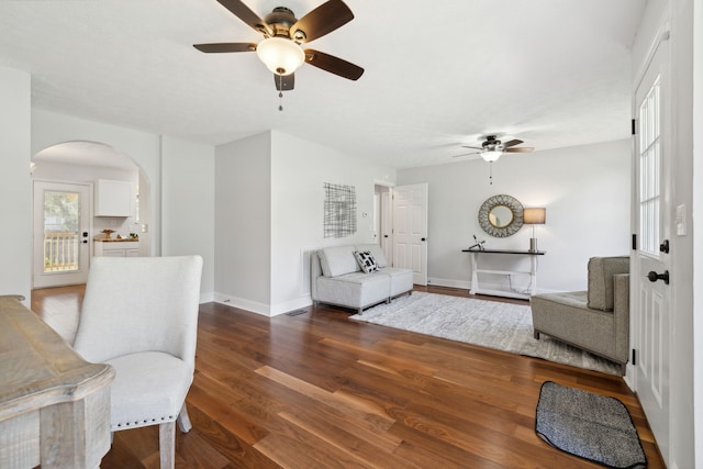 living room with wood-type flooring and ceiling fan