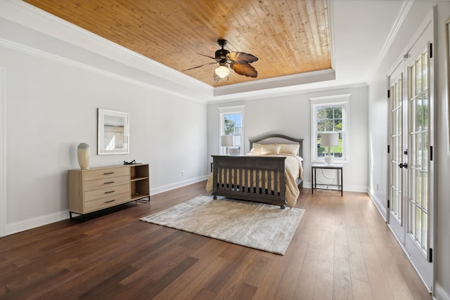 bedroom with french doors, a tray ceiling, wooden ceiling, crown molding, and dark hardwood / wood-style flooring