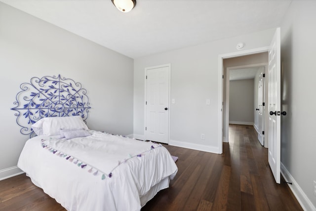 bedroom with dark hardwood / wood-style floors