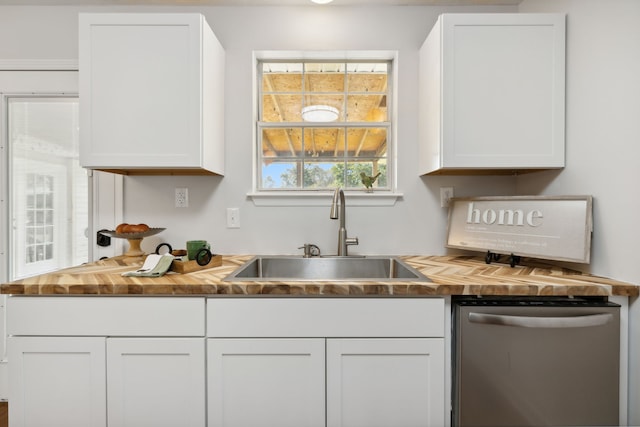 kitchen with stainless steel dishwasher and white cabinetry