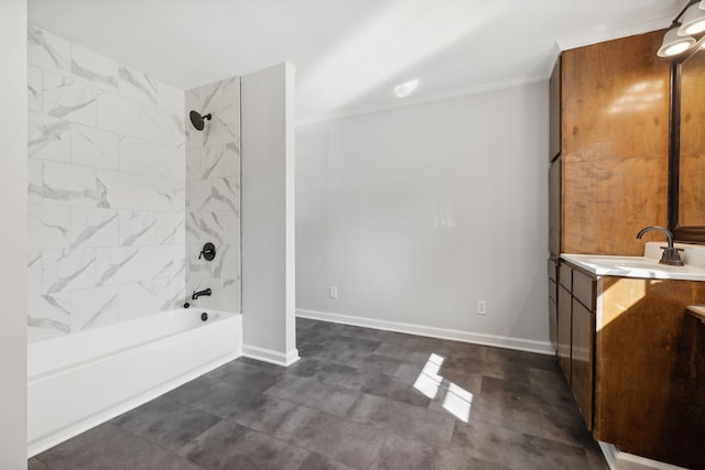 bathroom with ornamental molding, vanity, and tiled shower / bath