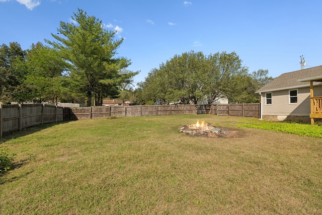 view of yard with a fire pit