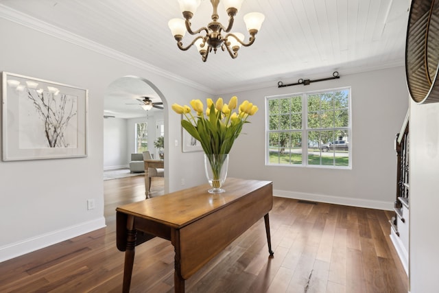 office space featuring ornamental molding, ceiling fan with notable chandelier, dark hardwood / wood-style flooring, and wood ceiling