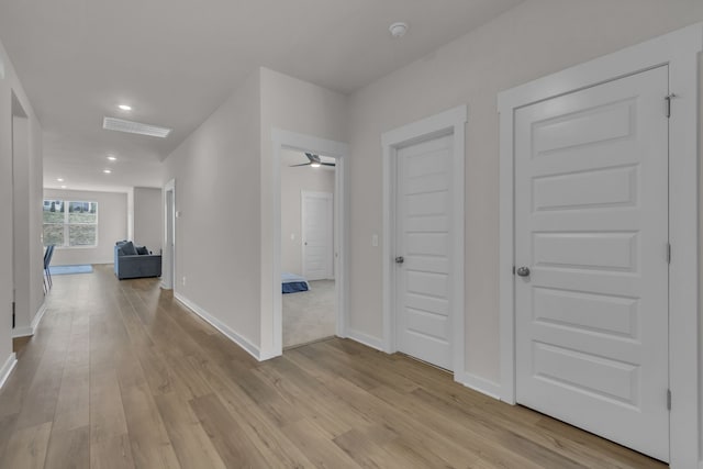 corridor with light hardwood / wood-style floors