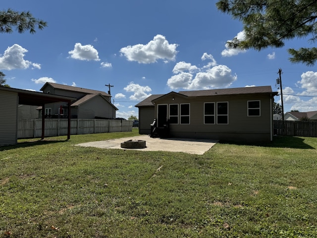 back of property featuring a lawn, a patio area, and an outdoor fire pit